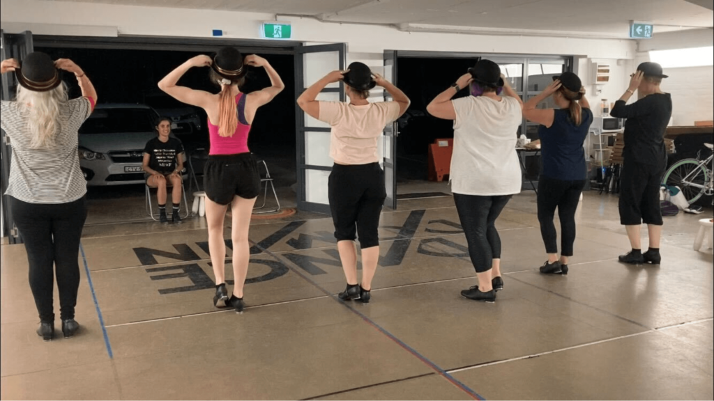 adult tap dance performers practicing their dance away from the mirror